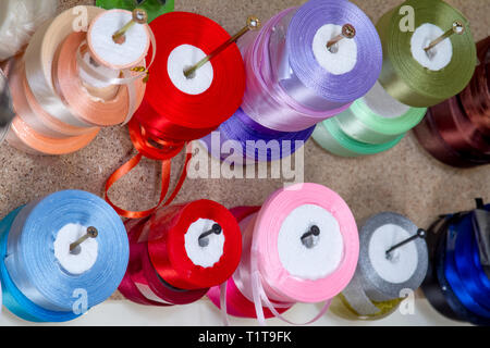 haberdashery haberdasher ribbon reels rolls rows and trims in fabric retail shop sew sewing supplies for sale retail shop market Stock Photo