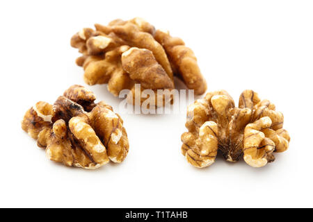 Three Walnut halves of Walnuts shelled nuts isolated on a white background. England UK Britain Stock Photo