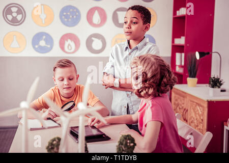 Little students sitting in class room and playing Stock Photo