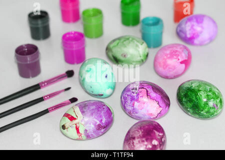 Painted Easter eggs. Special paint for Easter eggs. Paint eggs with paint and whale. Marble colored eggs. Pastel shades. Stock Photo