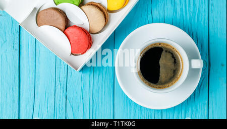 Macaroons with coffee on table Stock Photo