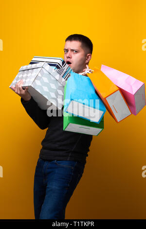Photo of male shopper with paper bags and boxes Stock Photo