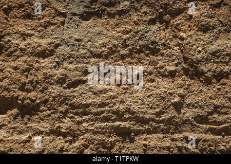 Rough plaster on an old wall forming a quaint background at Caceres. A charming town with a fully preserved old city center in Spain. Stock Photo