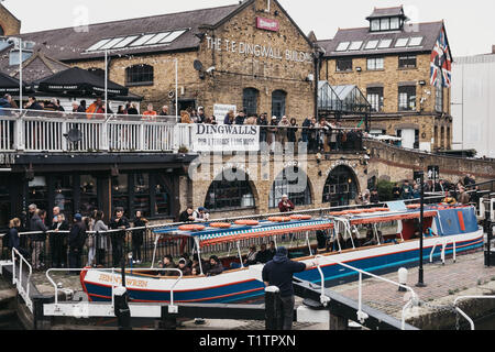 London, UK - March 23, 2019:  Tour boat passing Camden Market on Regent's Canal, London. In 2020 the Regent’s Canal will be 200 years old. Stock Photo