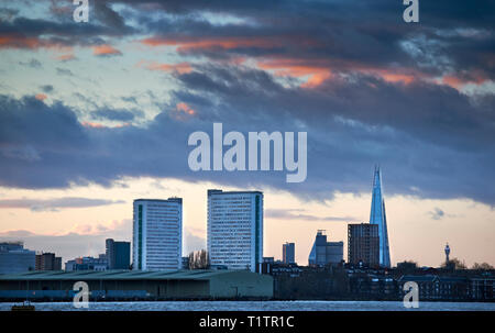 LONDON CITY SKYLINE EVENING WITH ORANGE CLOUDS OVER THE SHARD TWO TOWER BLOCKS AND RIVER THAMES Stock Photo