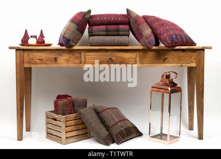 Sideboard style table with cushions and candles on a white background Stock Photo