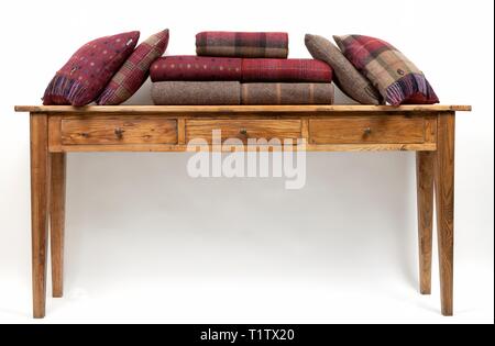 Sideboard style table with cushions on a white background Stock Photo