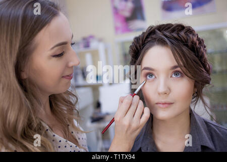 The work of a professional makeup artist. Stylist makeup artist doing makeup and hair in a beauty salon. Professional make-up Stock Photo