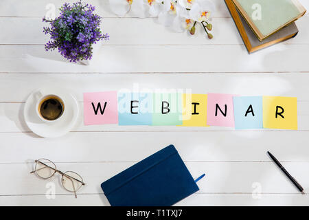 WEBINAR. Message at colorful note papers on a desk background. Lifestyle, business, office, motivation, plan, success, goal and management concept. Top or flat lay view. Stock Photo