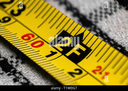 Yellow Tape measure showing measurement in metres and feet Stock Photo