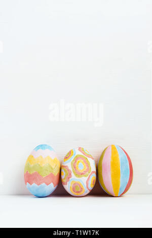Сolorful Easter eggs decorated with geometric patterns on white background Stock Photo