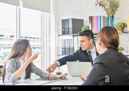 Financial report analysis and reviewing concept :CFO or chief financial officer sees financial summary reports with his secretary team and discusses Stock Photo
