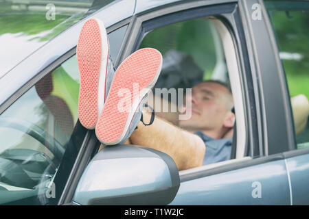 Man sleeping in the car before next part of the jurney Stock Photo