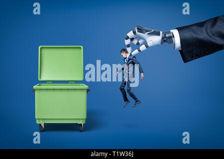 Big robotic hand in suit holding little businessman in order to throw him right into trash can. Stock Photo