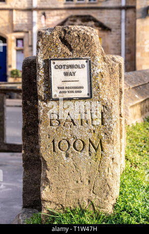 Evening light on the stone marker post depicting the beginning and the end of the Cotswold Way National Trail at Chipping Campden, Gloucestershire UK Stock Photo
