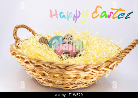 Painted Easter Eggs in a Farm Basket and Text in English Happy Easter Stock Photo