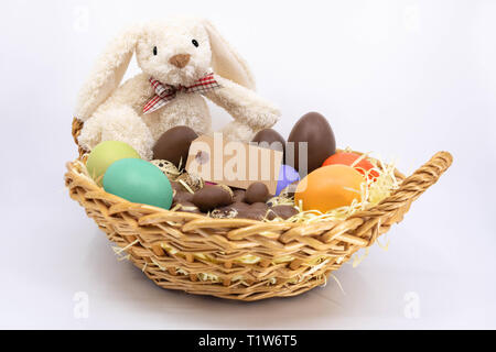 Easter Trim Basket with Painted Eggs, Chocolate Eggs and Quail Eggs with Easter Bunny Stock Photo
