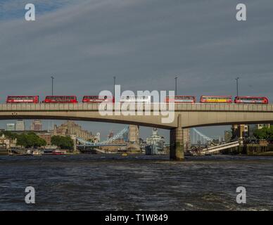 A queue of double-decker buses attempting to cross London Bridge, London, England. Stock Photo