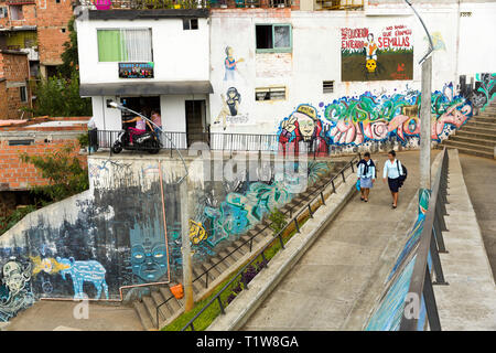 Colombia: Medellin. Two women walking in a street of one of the working-class districts atop the hills overhanging the capital city of the Antioquia D Stock Photo