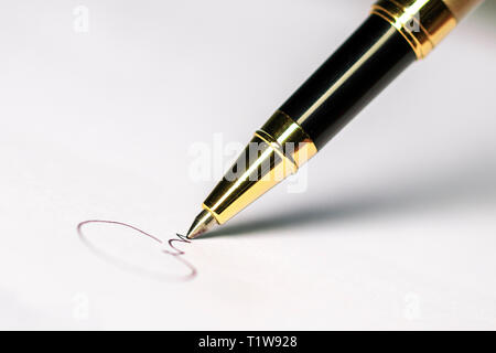 Pen and signature on paper background Selected focus Stock Photo