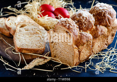 Easter Breads with decorated red painted eggs on dark background Stock Photo