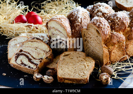 Easter Breads with decorated red painted eggs on dark background Stock Photo