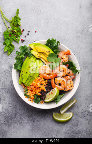 Tasty salad with avocado, shrimps, red tomatoes, cucumber, arugula ...