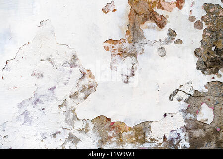 Old plastered brick wall with damaged plaster Stock Photo