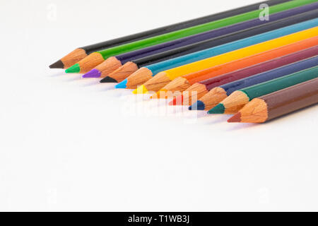 A group of colored pencils on white background, all in focus. Stock Photo