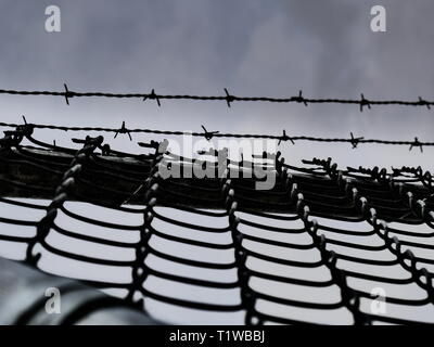 High security fence and sky Stock Photo