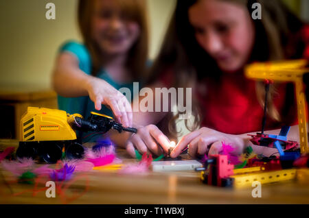 Two Girls Play With Science and Technology Kits Stock Photo