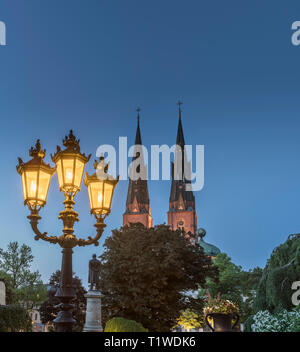 Old lamp post and the Cathedral and Gustavianum at night. View from the University park, Uppsala, Sweden, Scandinavia Stock Photo