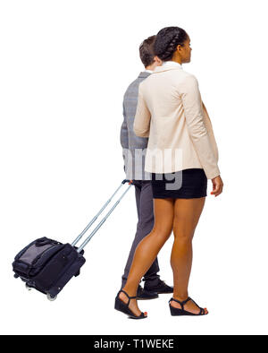 Back view of interracial going couple with suitcase. Rear view people collection. backside view of person. Isolated over white background. Husband and Stock Photo