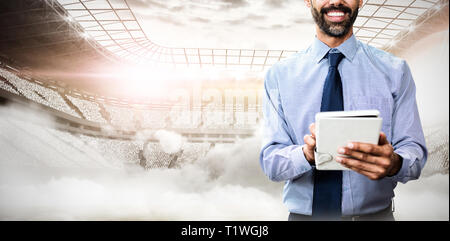 Composite image of portrait of smiling businessman using tablet computer Stock Photo