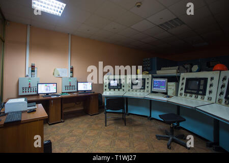 The theme of enterprise and plant automation. Inside the factory control center, monitors with information on the operation of the systems, workplace Stock Photo