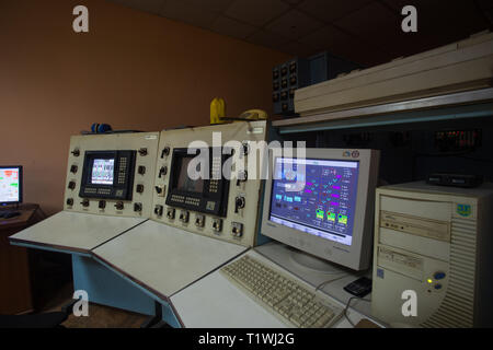 The theme of enterprise and plant automation. Inside the factory control center, monitors with information on the operation of the systems, workplace Stock Photo
