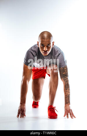 Sportive bold man getting ready for running Stock Photo