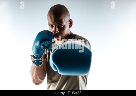 Man wearing boxing gloves standing in a boxing pose Stock Photo