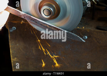 Worker fabrication knife a circular saw blade sharpening Circular Saw, Stock Photo