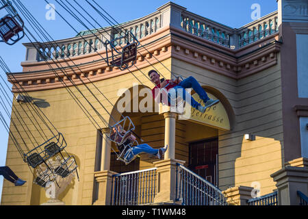 Vienna, Austria - September , 16, 2019: Side view of kids having fun at spinning Luftikus carousel or chain swing ride, in Prater amusement park Stock Photo