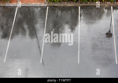 Empty wet parking lot in rain Stock Photo