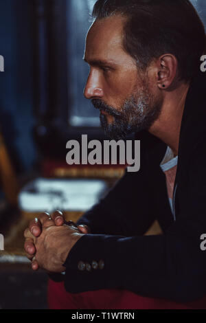 A Bearded Man Freelancer in a Black Jacket With a Beautiful Appearance. Stock Photo