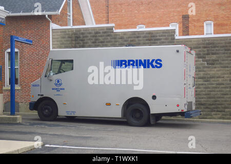 An armoured brinks truck delivering money to an ATM. Stock Photo