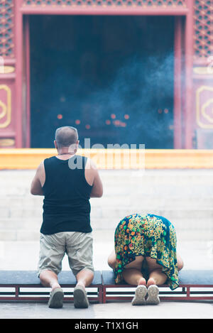 Beijing, China - 08 01 2016: Chinese people praying in front of a temple in Beijing, China Stock Photo