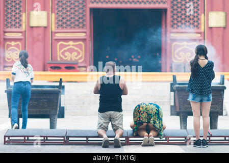 Beijing, China - 08 01 2016: Chinese people praying in front of a temple in Beijing, China Stock Photo