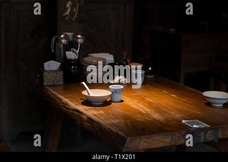 Pingyao, China - 08 13 2016: Asian spoon and bowl in a chinese traditional restaurant in Pingyao, China Stock Photo