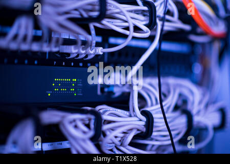 optical cables connected to main server in the server room at data center Stock Photo
