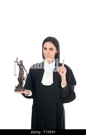 Judge in judicial robe holding themis figurine and showing idea gesture isolated on white Stock Photo