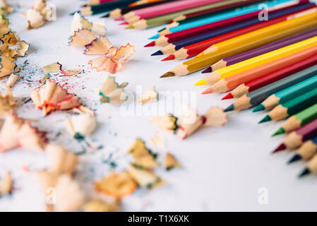 Sharpened crayons and colored shavings on paper Stock Photo