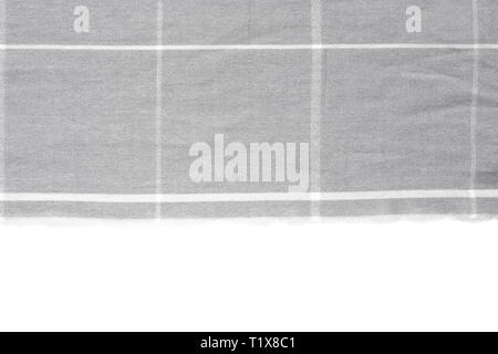 A piece of gray checked fabric is isolated on a white background with an area for text Stock Photo
